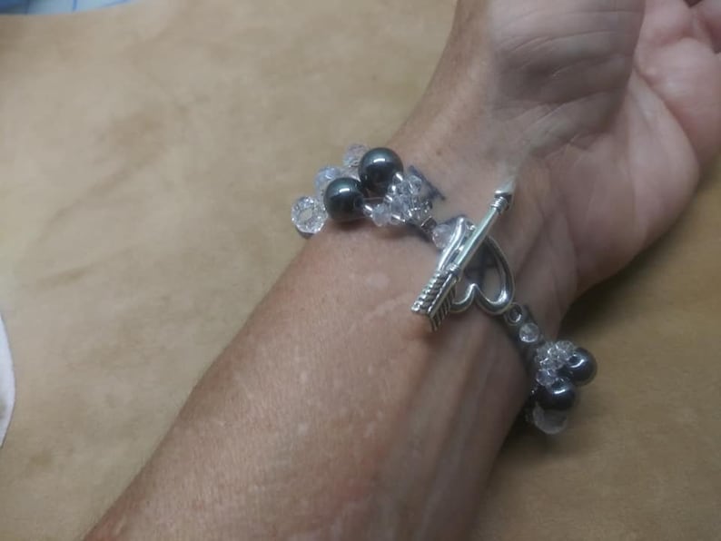 Bracelet 6 strand black hematite and crystal with arrow an heart toggle clasp.