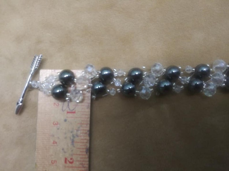 Bracelet 6 strand black hematite and crystal with arrow an heart toggle clasp.