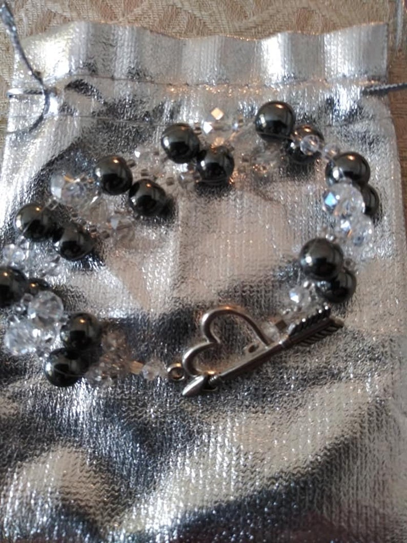 Bracelet 6 strand black hematite and crystal with arrow an heart toggle clasp.