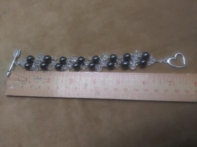 Bracelet 6 strand black hematite and crystal with arrow an heart toggle clasp.