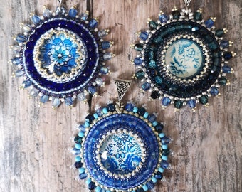 Pendant made of glass cabochon braided with Japanese beads and Czech glass beads