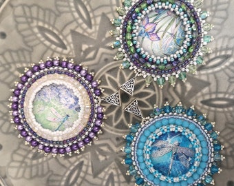 Pendant made of glass cabochon braided with Japanese beads and Czech glass beads