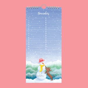 May include: A November calendar with a charming illustration of a snowman and a dachshund. The snowman wears a pink hat and yellow scarf. The calendar has a spiral binding and is set against a snowy, wintery backdrop.
