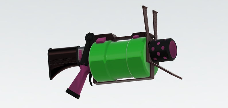 Puede incluir: Un arma de juguete verde y rosa con un mango negro y un ca&ntilde;&oacute;n rosa y negro. El arma tiene un marco de metal y un cilindro verde.