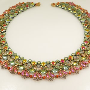 May include: A multi-layered necklace made with iridescent green, orange, and pink beads. The necklace features a variety of bead shapes, including teardrop, square, and crescent.