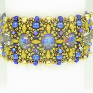 May include: A gold and blue beaded bracelet with iridescent glass beads. The bracelet is made with a variety of seed beads and features a geometric pattern.