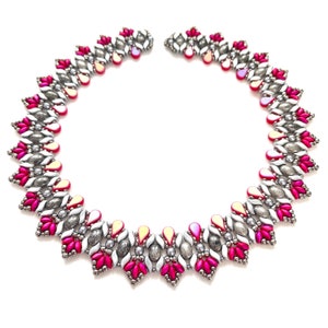 May include: A pink and silver beaded necklace with a geometric design. The necklace is made with small, round beads and has a delicate, feminine look.