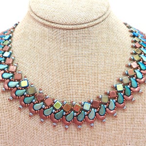 May include: A beaded necklace featuring a repeating pattern of metallic copper-colored teardrop beads, square beads in shades of green and bronze, and small silver-toned accent beads arranged in a structured, multi-layered collar design.
