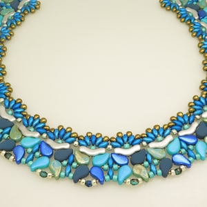 May include: A blue, green and gold beaded necklace with a geometric pattern. The necklace is made of various sizes and shapes of beads.