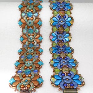 May include: Two beaded bracelets. One is copper and turquoise, the other is blue and green. Both feature floral designs with iridescent accents. The bracelets are made with small beads and have a clasp closure.