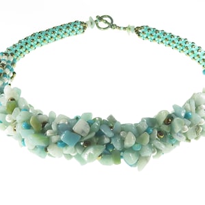 May include: A turquoise and gold beaded necklace with a cluster of aqua blue, green, and white stones.