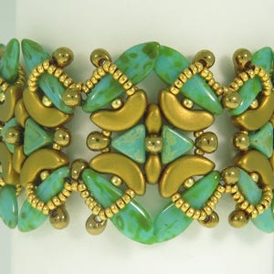 May include: A gold and teal beaded bracelet with a geometric pattern. The bracelet is made with small, round beads and larger, faceted beads.