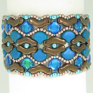 May include: A beaded bracelet with a geometric pattern in shades of blue, brown, and teal.