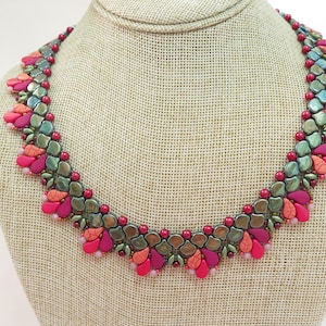 May include: A beaded necklace with a floral design. The necklace features a mix of colors, including pink, orange, and green beads. The necklace is displayed on a mannequin.
