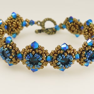 May include: A gold and blue beaded bracelet with a clasp fastening. The bracelet features a repeating pattern of blue and gold beads.
