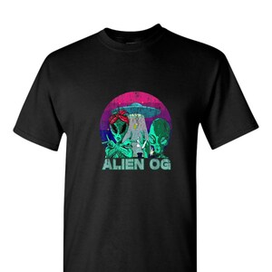 May include: Black t-shirt with a graphic featuring two green aliens, a UFO, and the text "ALIEN OG." The design is set against a retro sunset backdrop with pink, purple, and blue hues.