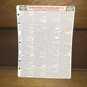 May include: A white Quick Chart reference sheet titled "Literature Vocabulary" with a simplified summary and instant reference. The sheet has a list of vocabulary terms and definitions, with a hole-punched edge for binder storage.