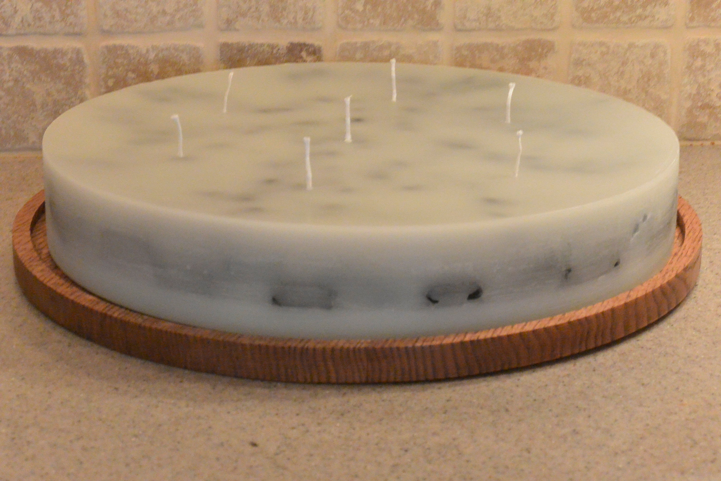 One of a kind 18 inch round candle with 7 wicks. Includes hand made oak