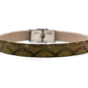 May include: A brown leather bracelet with a silver buckle. The bracelet is made from recycled tire material and has a geometric pattern.