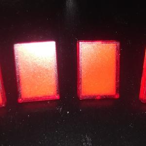 May include: Four red rectangular light-up buttons.