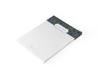 May include: A lined notepad with a blue floral header featuring orange and white flowers. The header includes a white label with the text Scripture Notes in blue script. The bottom left corner of the page features small blue text reading Notes by Heart.