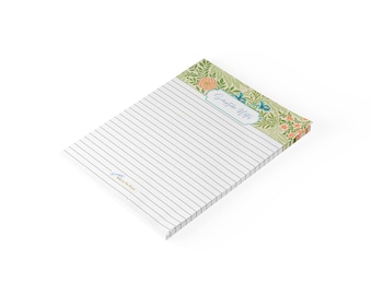 May include: A rectangular notepad with lined white paper. The top header features a green botanical pattern with orange flowers and blue accents. A central label reads Scripture Notes, and a small logo is printed in the bottom left corner.