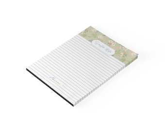 May include: A rectangular notepad with horizontal black lines and a top header featuring a light green background with white floral patterns. The header includes the text Scripture Notes in a cursive font, and the bottom left has small text.