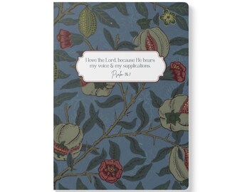 May include: A rectangular notebook with a blue background featuring a botanical pattern of green leaves, brown branches, and red flowers. A central white label contains the text: I love the Lord, because He hears my voice & my supplications. Psalm 116:1.