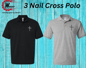 May include: Two polo shirts featuring a 3 Nail Cross design. One shirt is black and the other is grey. The shirts are displayed against a blue wooden backdrop. The text "Worship gear by SewB's" is at the bottom of the image.