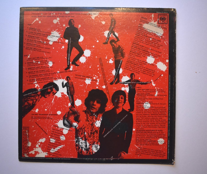 May include: Back cover of a vinyl record with a red and white splatter paint design. The record is titled "The Best of Jefferson Airplane" and features a photo of the band members. The track list is printed on the left side of the cover.
