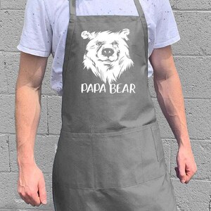 May include: A gray apron with a white bear illustration and the text "Papa Bear".