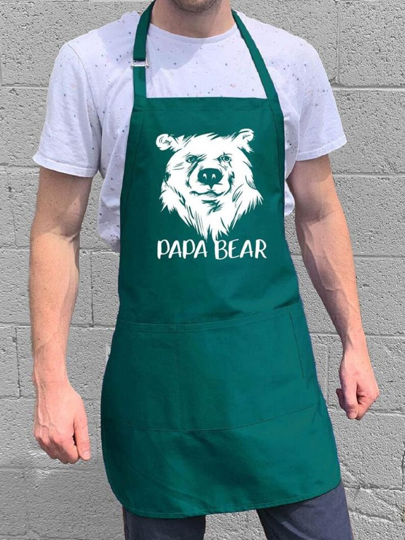 May include: A green apron with a white bear graphic and the text "Papa Bear".