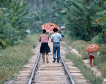 Family walking along Korean railroad tracks, by Marvin Koner