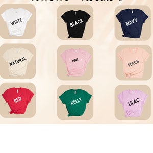 May include: A color chart displays nine t-shirts in various colors: white, black, navy, natural, pink, peach, red, kelly green, and lilac. Each shirt has the color name printed on it in a contrasting color. The text "Color Chart" is at the top.