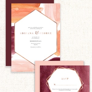 May include: Wedding invitation with a watercolor background in shades of pink, orange, and burgundy. The invitation features a gold hexagonal frame with the text "Adriana & George" and wedding details. The RSVP card features a gold octagonal frame with a burgundy watercolor background.