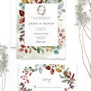May include: A wedding invitation with a watercolor floral wreath in shades of red, green, blue, and gold. The invitation text reads "you are cordially invited to attend the wedding of Anne & David on October 15 at 4:30 pm at Avenue Plaza Crystal Palace Charleston Reception to follow". The RSVP card features the same floral wreath and the text "RSVP Please let us know by 1st September so we can make arrangements accordingly."