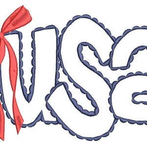 May include: Embroidered design spelling "USA" in white, outlined with a scalloped navy blue border. A red bow with flowing ribbons is attached to the left side of the letters. The design is on a white background.