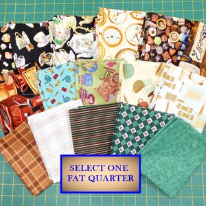 May include: A selection of 16 fat quarter fabric squares featuring various kitchen and home-themed prints. The prints include teacups, clocks, chocolate, kitchen utensils, and more. The fabric squares are arranged on a green cutting mat with the text "SELECT ONE FAT QUARTER" in a white rectangle.