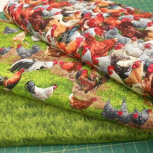 May include: Two pieces of fabric featuring a repeating pattern of colourful roosters and hens against a green grassy backdrop.
