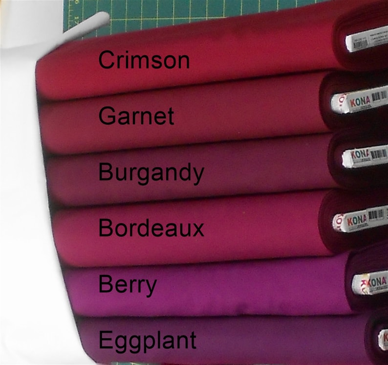 May include: Six fabric swatches in various shades of red and purple, from crimson to eggplant. The swatches are labeled with the color names: Crimson, Garnet, Burgundy, Bordeaux, Berry, and Eggplant.