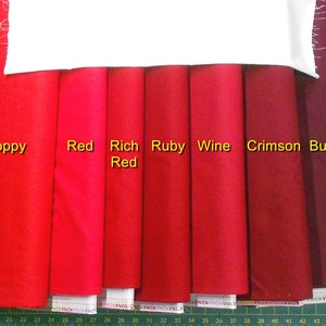 May include: A comparison of eight different shades of red fabric swatches, labeled "Poppy", "Red", "Rich Red", "Ruby", "Wine", "Crimson", and "Burgandy".