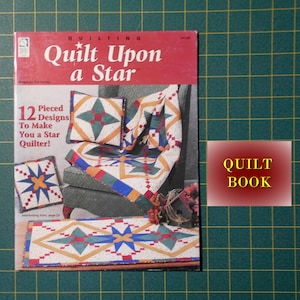 May include: A book titled "Quilt Upon a Star" with a red cover and a white star. The book features 12 pieced designs to make you a star quilter. The book cover shows a quilt with a star pattern in red, green, blue, and yellow.