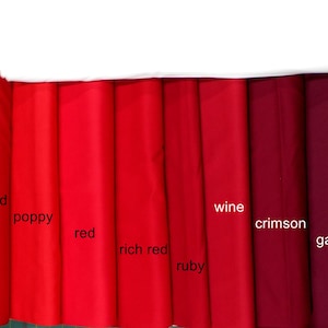 May include: A swatch card of ten different shades of red fabric, from light to dark. The swatches are labeled with the names "Chinese Red", "Poppy", "Red", "Rich Red", "Ruby", "Wine", "Crimson", "Garnet", and "Burgundy".