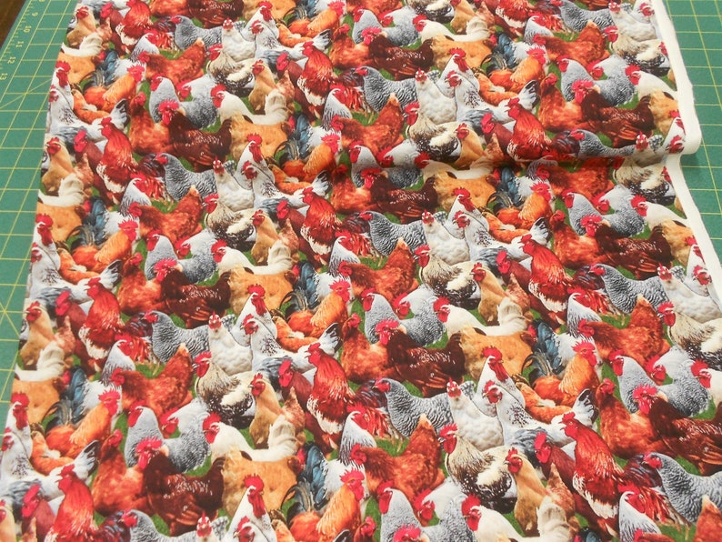 May include: A fabric featuring a repeating pattern of colourful chickens. The chickens are in various poses, including standing, walking, and pecking. The fabric is white with a subtle texture.