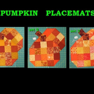 May include: Three pumpkin-shaped placemats made of patchwork fabric in shades of orange, yellow, and brown. Each placemat has a stem and is labeled with "set" and a number. The text "PUMPKIN PLACEMATS" is at the top.
