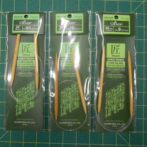 May include: Three packages of Clover Takumi Bamboo Premium Circular Knitting Needles. The packages are labeled with the size and length of the needles. The needles are made of natural bamboo and are designed for knitting circular projects.