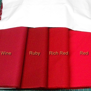 May include: Four fabric swatches in different shades of red, labeled "Wine", "Ruby", "Rich Red", and "Red".