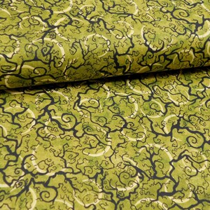 May include: Green fabric with a black and white swirling pattern. The pattern resembles branches and vines.
