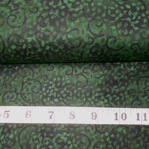 May include: Green fabric with a black swirl pattern. The fabric is measured with a tape measure that reads "4, 5, 6, 7, 8, 9, 10, 11, 12" in inches.