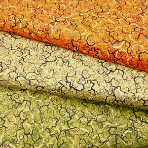 May include: Three fabric swatches with a swirling, vine-like pattern. The top swatch is orange, the middle swatch is beige, and the bottom swatch is green.